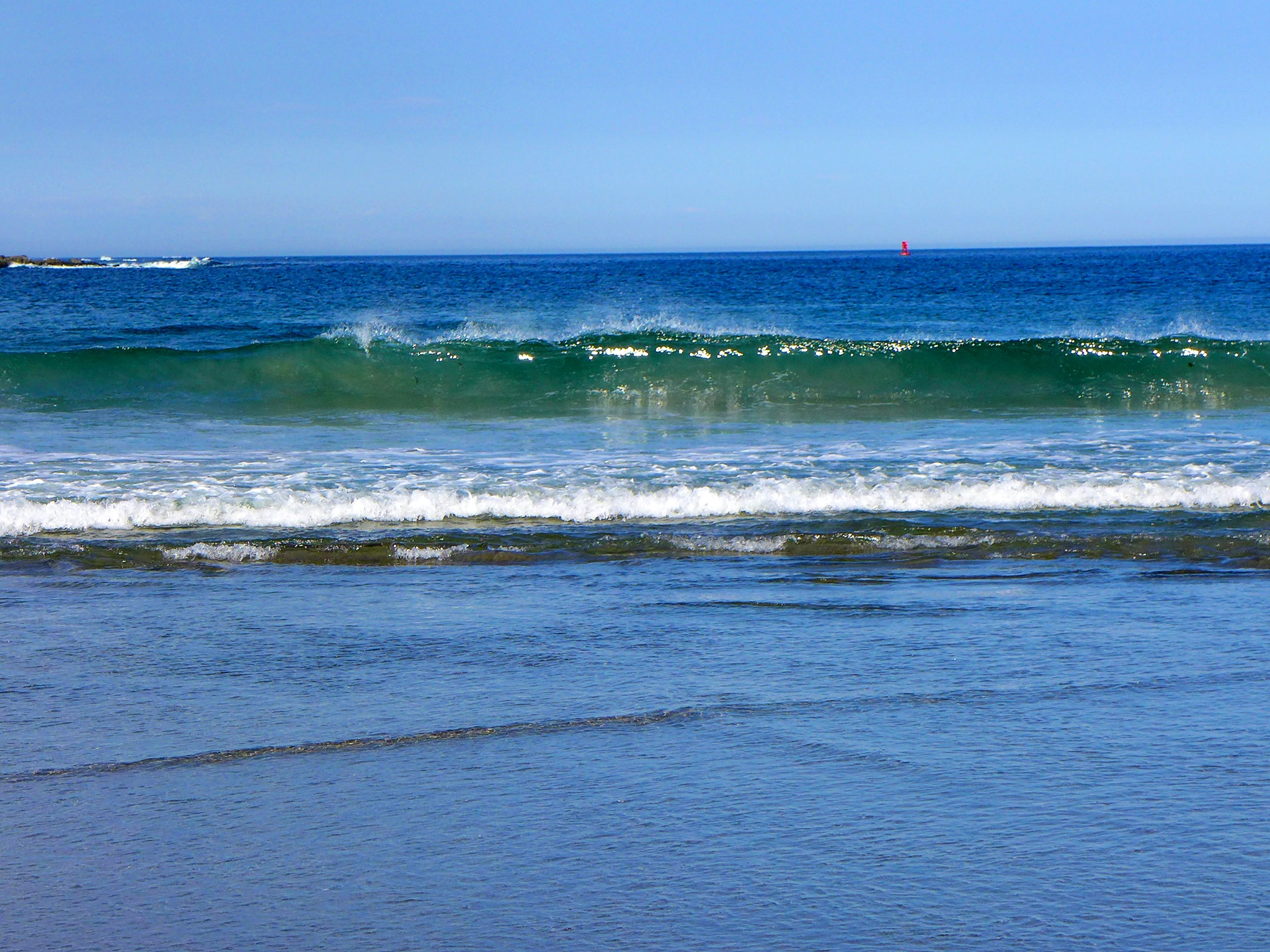 Green colored waves at Long Sands Beach in York Beach, Maine