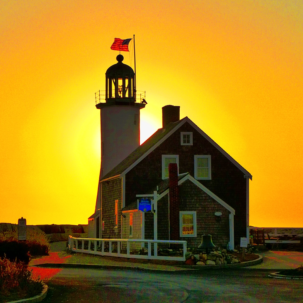 Scituate Lighthouse in Scituate, Mass. is surrounded by sun in the morning.
