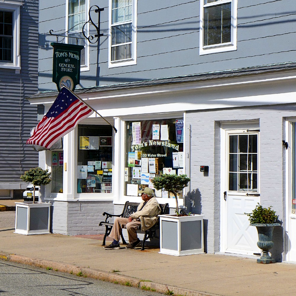 Taking in small town life in front of Tom's General Store in Stonington Borough, Conn.